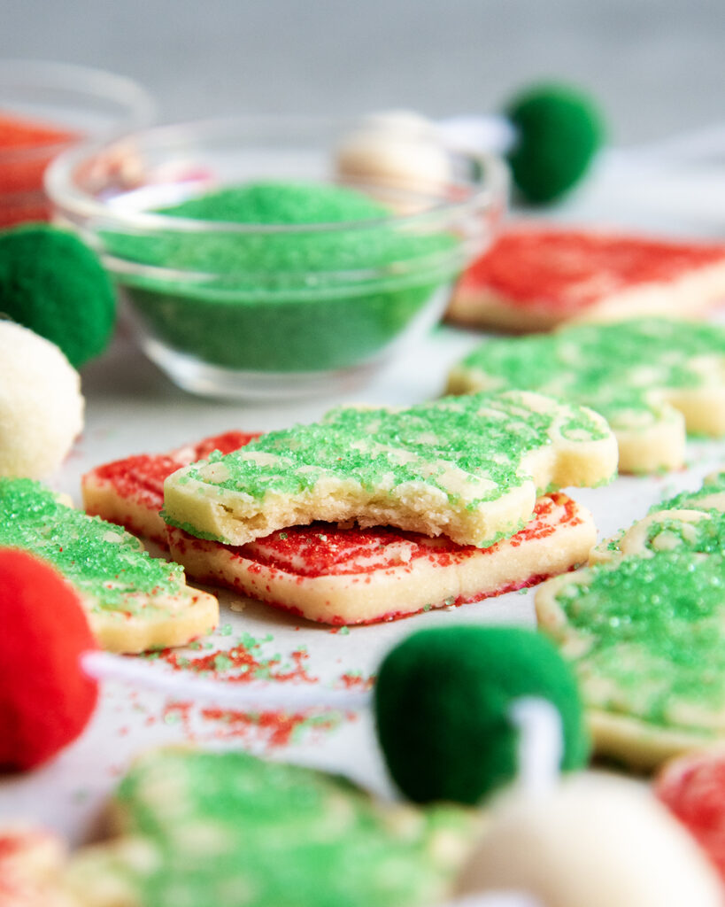 A stack of two shortbread cookies and the top cookie has a bite out of it.