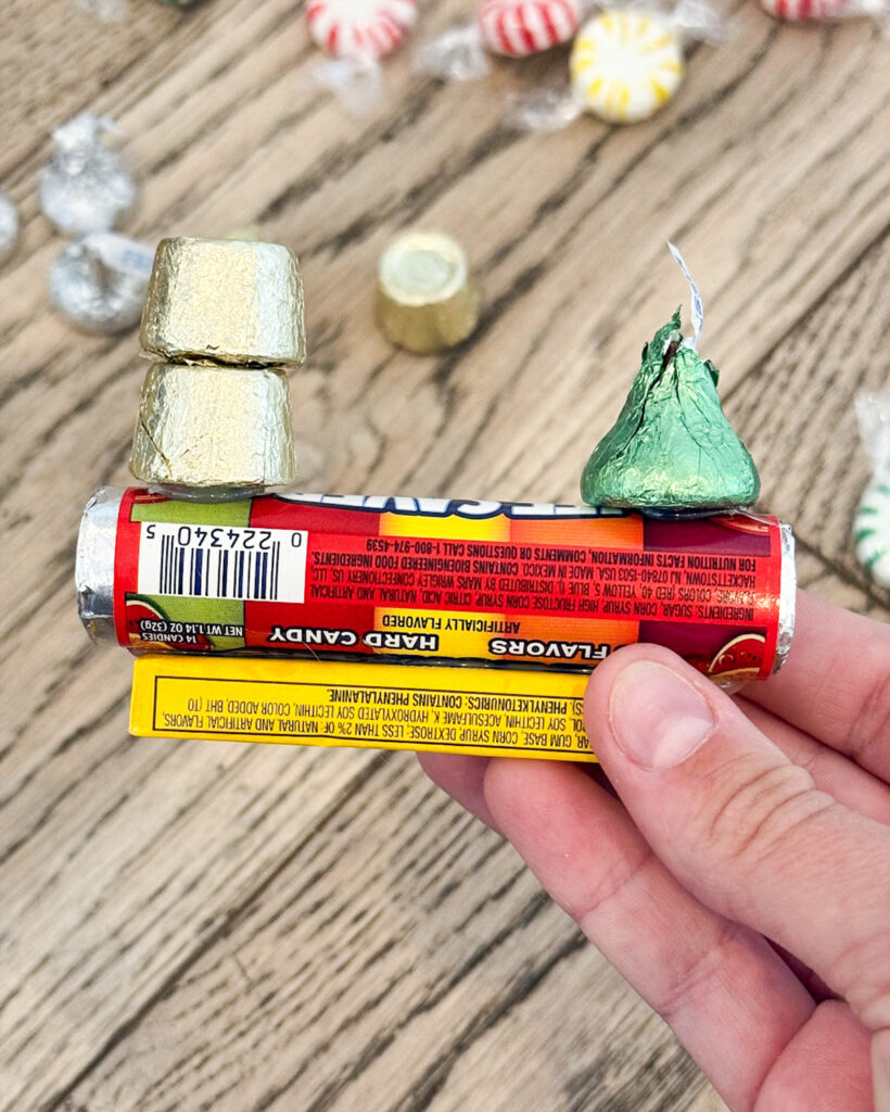 A hershey kiss glued onto a roll of life savers to make a candy train.