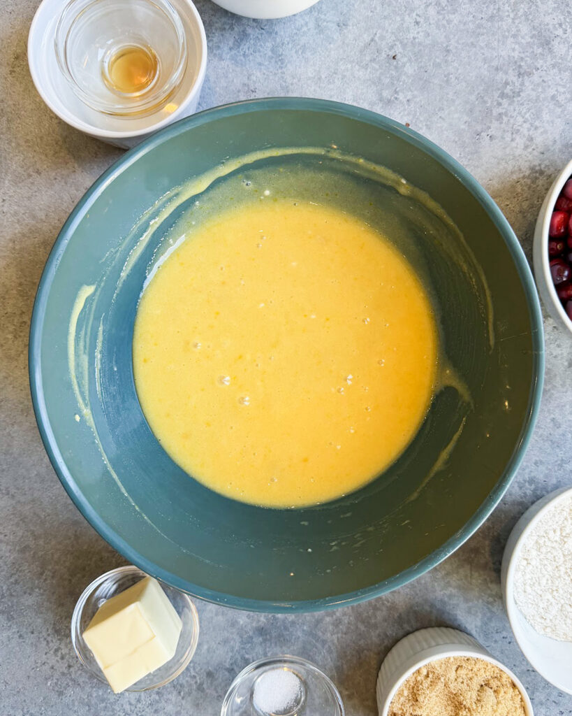 A yellow custard in a dark green bowl.