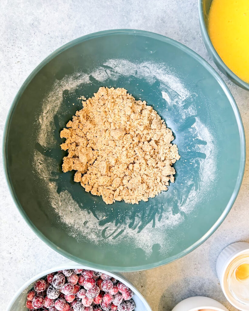 A brown sugar crumb topping in a green bowl.