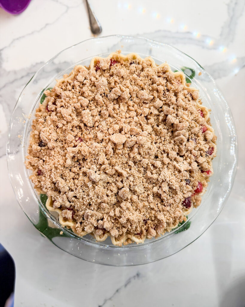 An unbaked crumb topping on top of a custard pie.