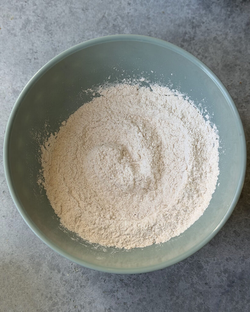 A bowl of flour, mixed with cinnamon and other spices.