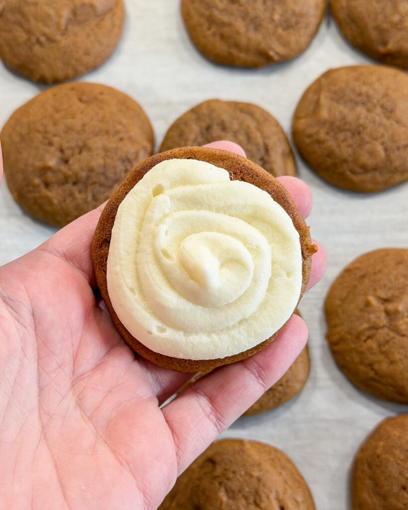 Half a whoopie pie topped with cream cheese frosting.