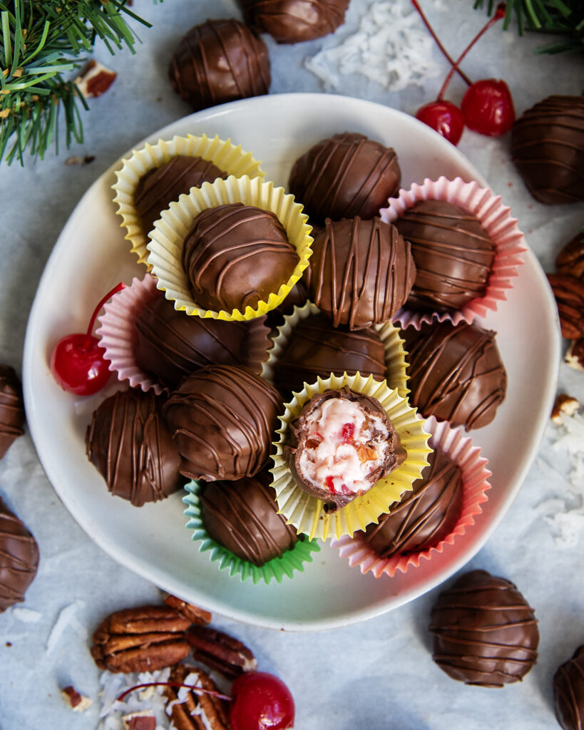 An above view of martha washington candies on a plate, some are cut open showing the filling in the middle.