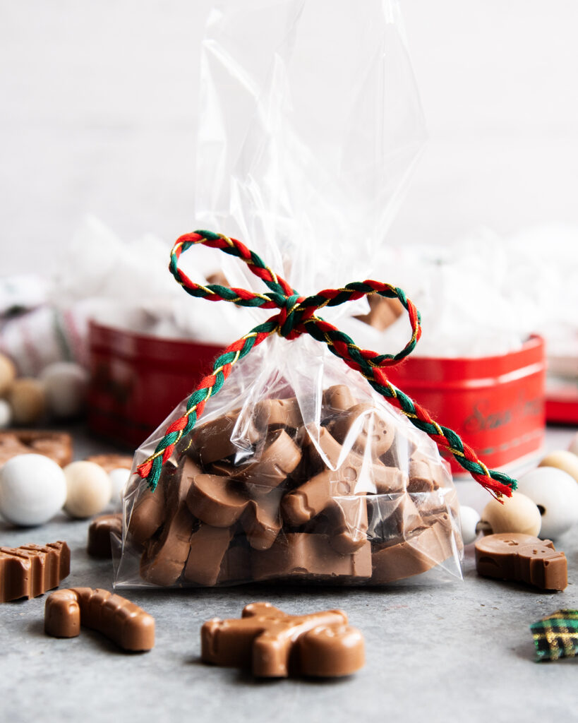 A bag of peanut butter meltaways next to a tin of them.