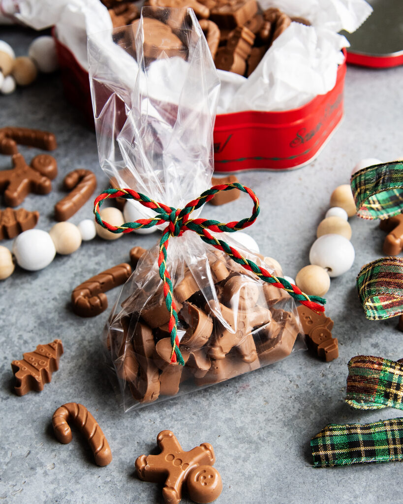 A bag of peanut butter meltaways next to a tin of them.
