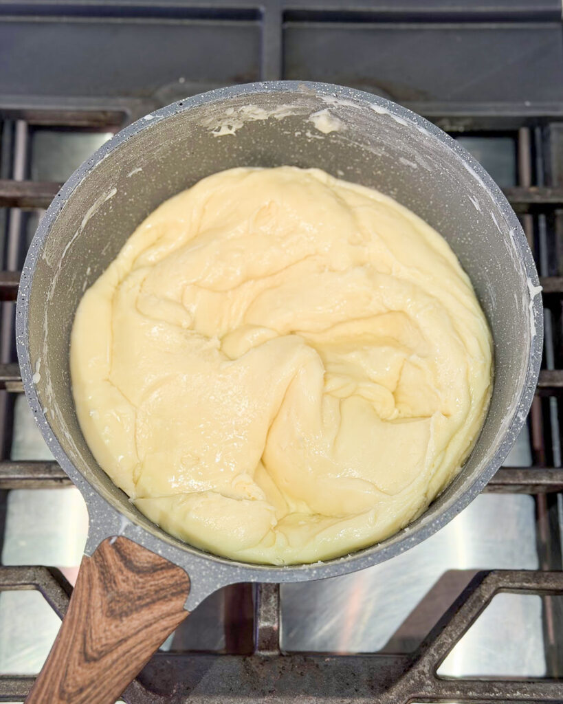 White chocolate fudge melting in a pot.