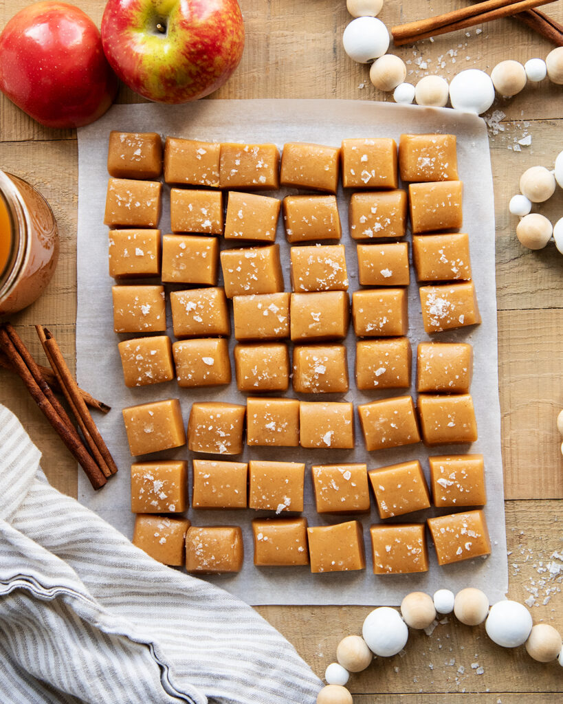 An above view of apple cider caramels topped with flakey sea salt.