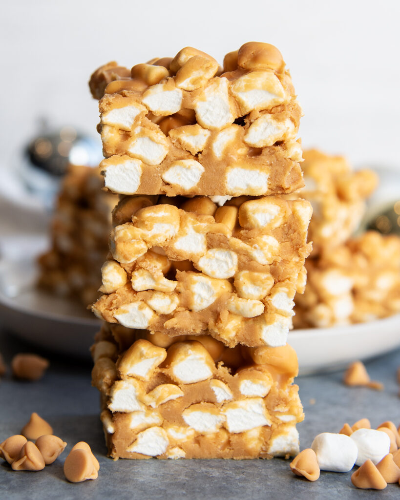 A stack of three squares of butterscotch marshmallow squares.