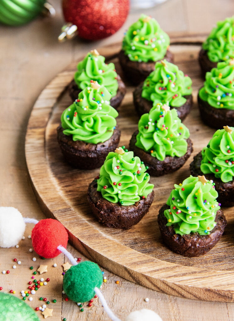 Christmas Tree Brownies on a wooden plate.