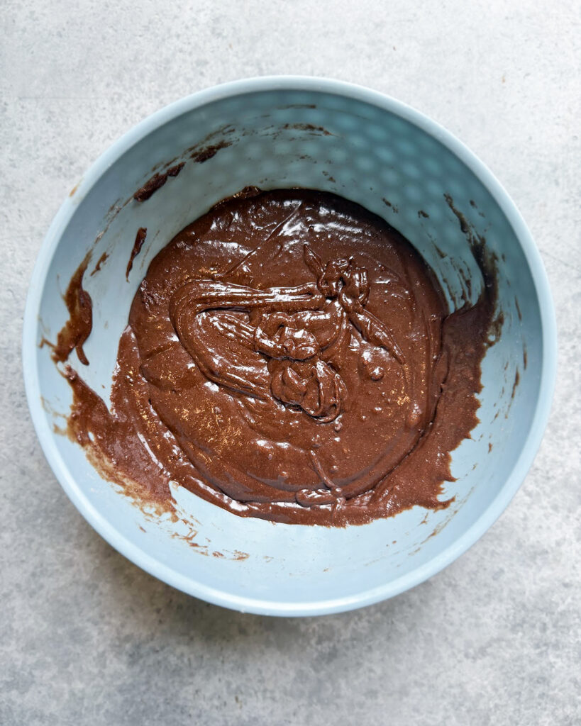 Brownie batter in a blue bowl.