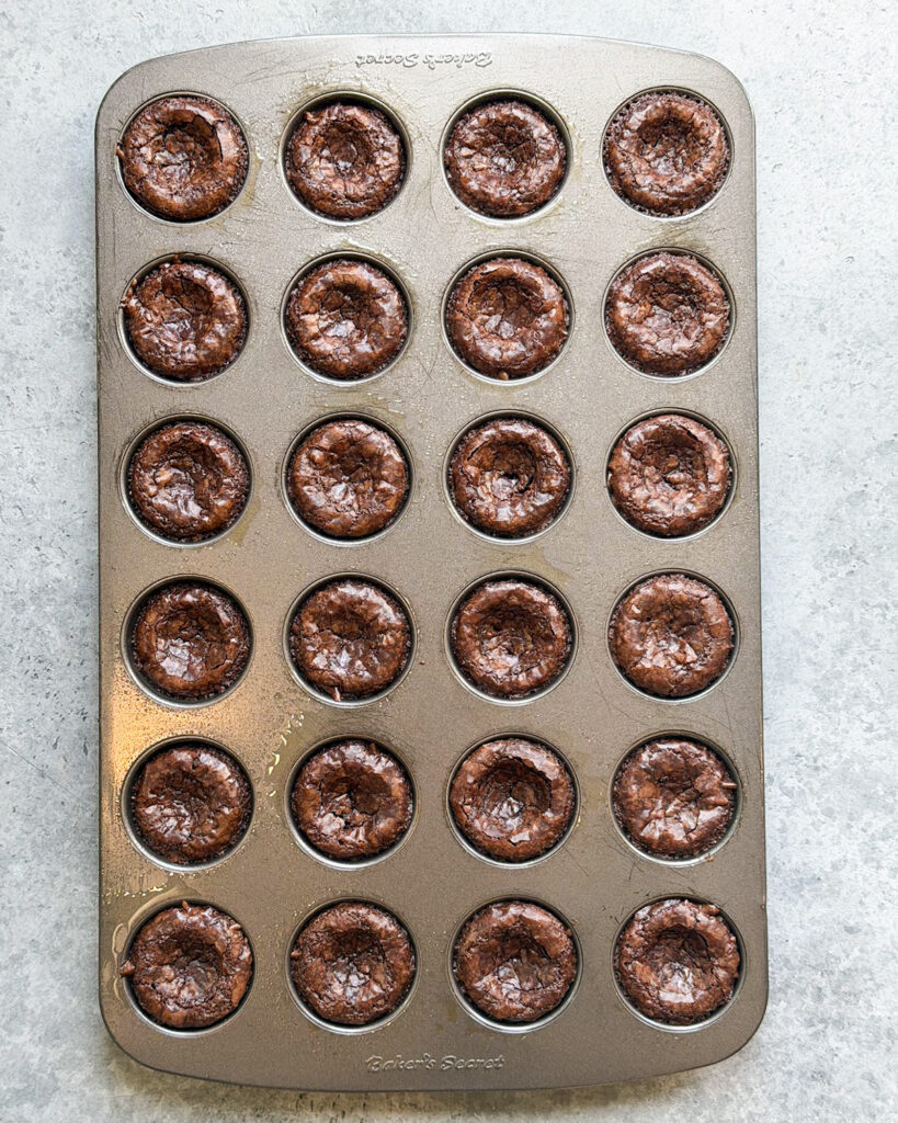 A mini muffin pan full of brownie bites.