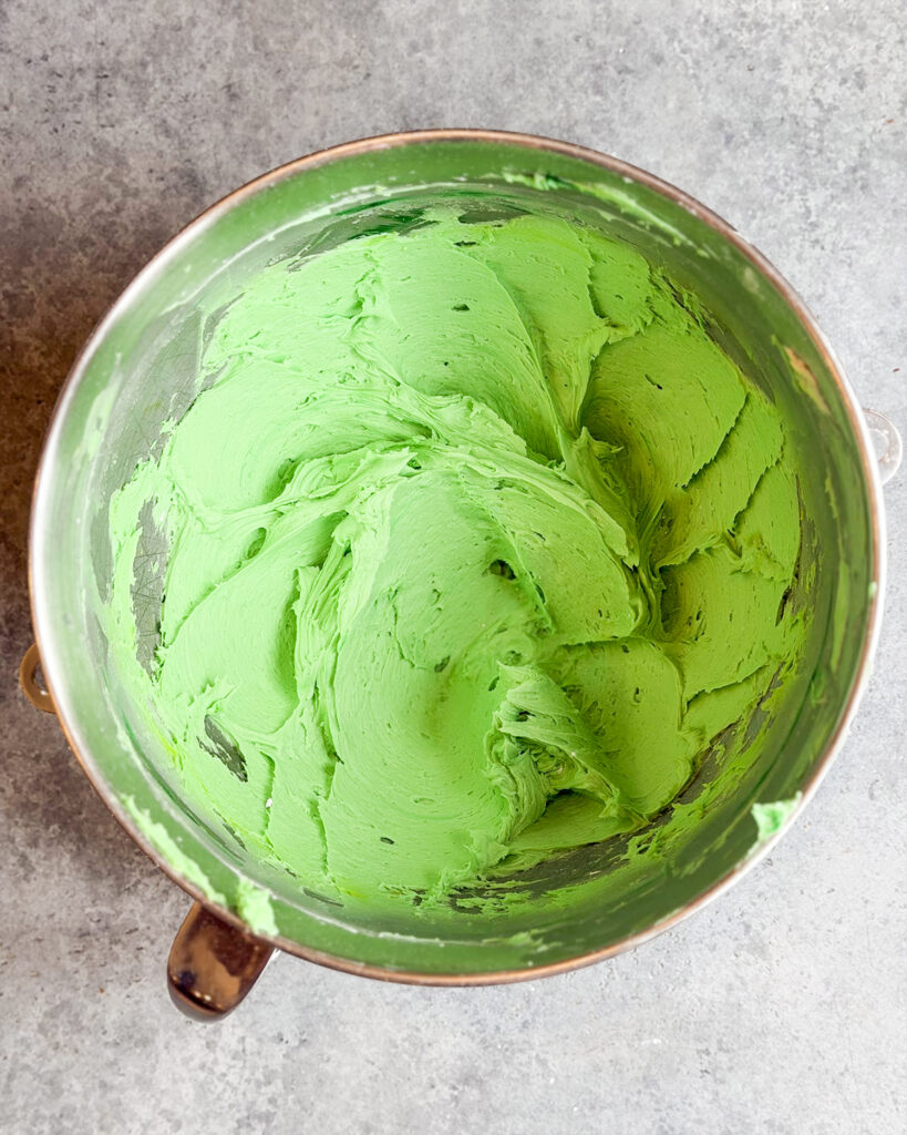 A metal bowl of green buttercream frosting!