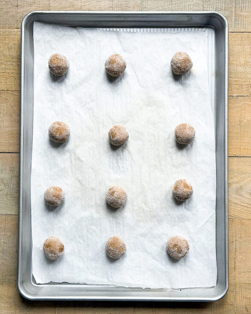 Ginger Cookie dough balls on a cookie sheet.