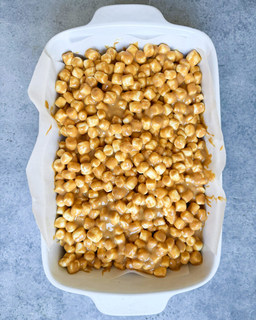 An above view of butterscotch marshmallow bars in a pan.