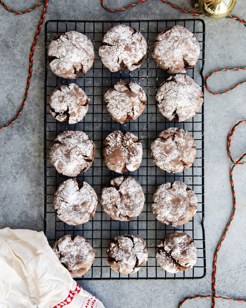 Rows of chocolate cake mix cookies on a cooling rack.