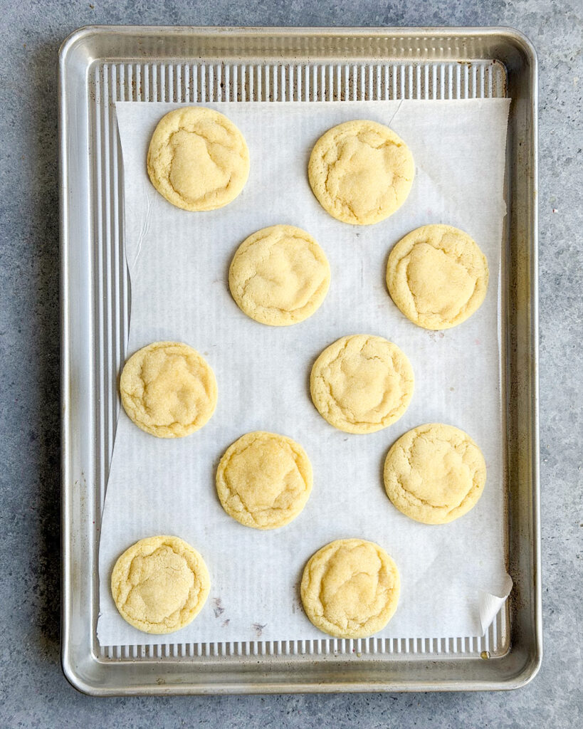 Drop sugar cookies on a cookie sheet lined with parchment paper.