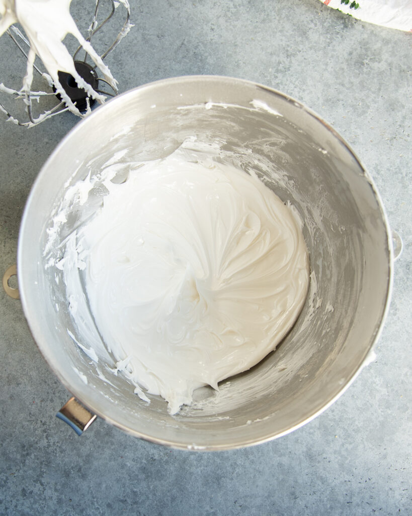 A mixing bowl with white stiff royal icing in it.
