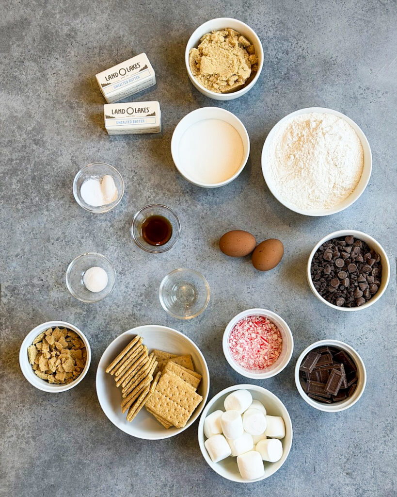 Small bowls of the ingredients needed to make peppermint smores cookies. 
