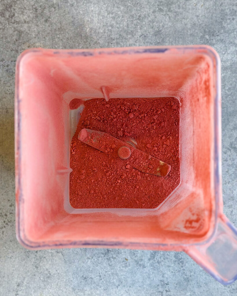 Pureed freeze dried strawberries in a blender.