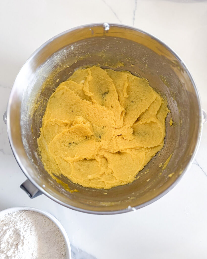 A bowl of creamed butter, sugar, and eggs to make cookie dough.  