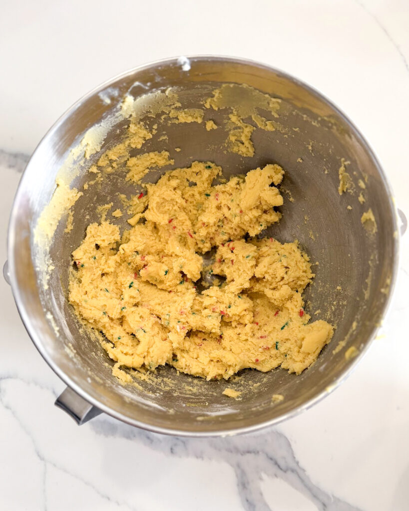 A funfetti cookie dough in a mixing bowl.