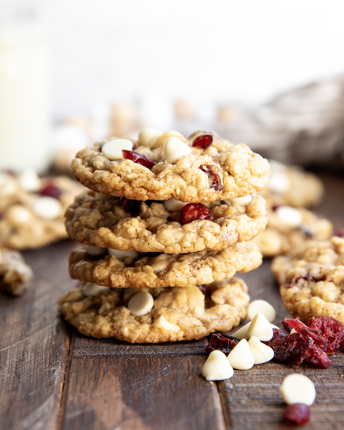A stack of four oatmeal white chocolate and cranberry cookies.