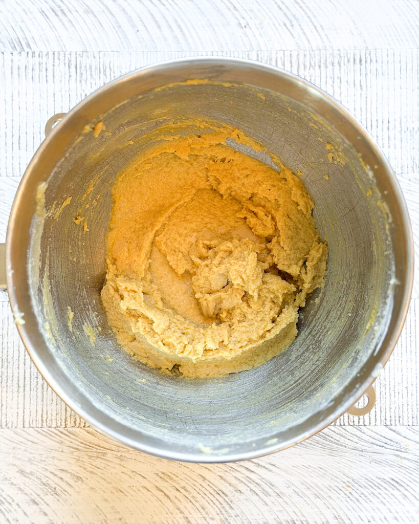 Creamed butter and sugar in a metal bowl.