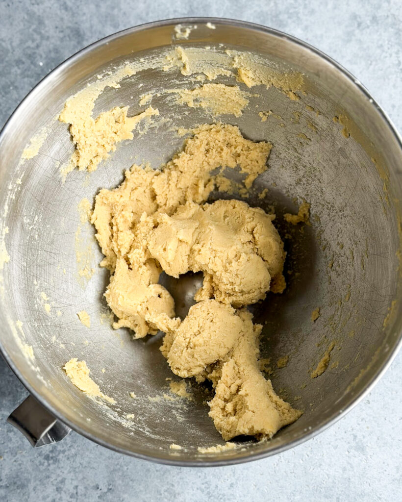 Cookie dough in a metal bowl.