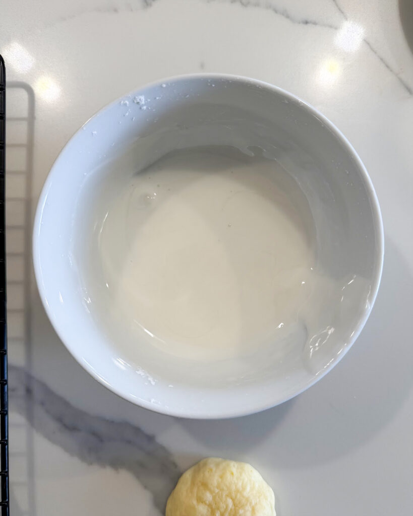 A bowl of lemon icing.