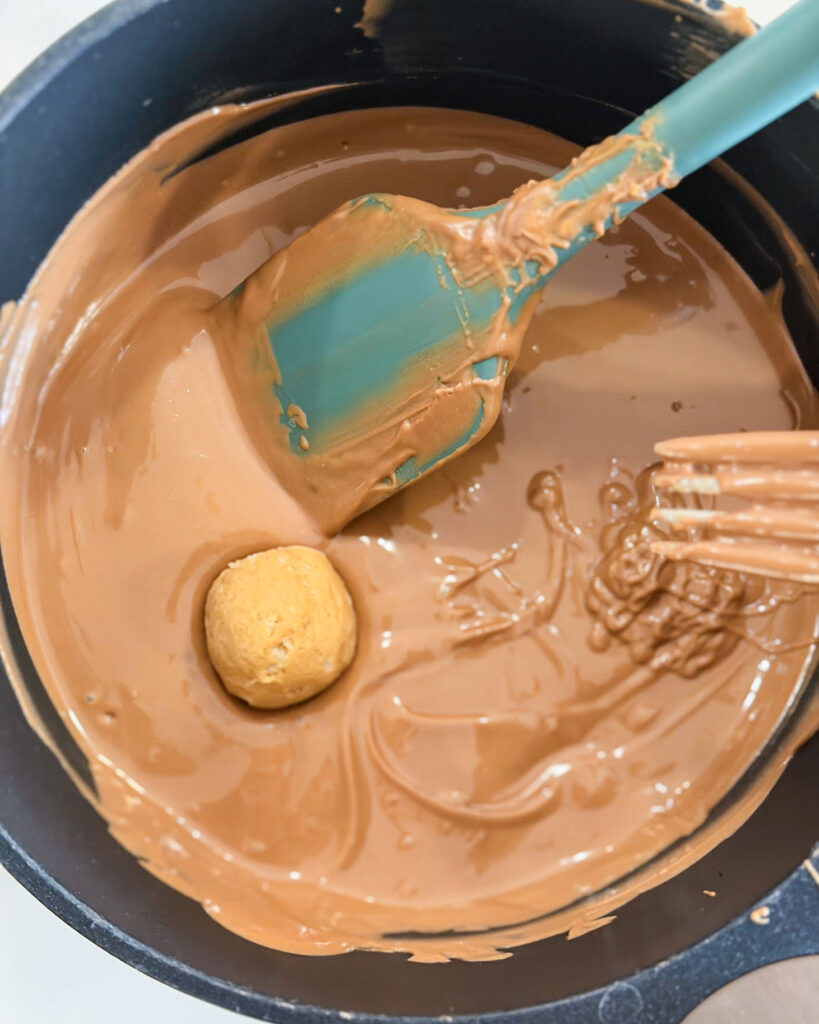 A peanut butter ball dipped in melted chocolate.