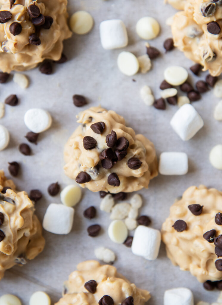 An above view of peanut butter avalanche cookies topped with mini chocolate chips.