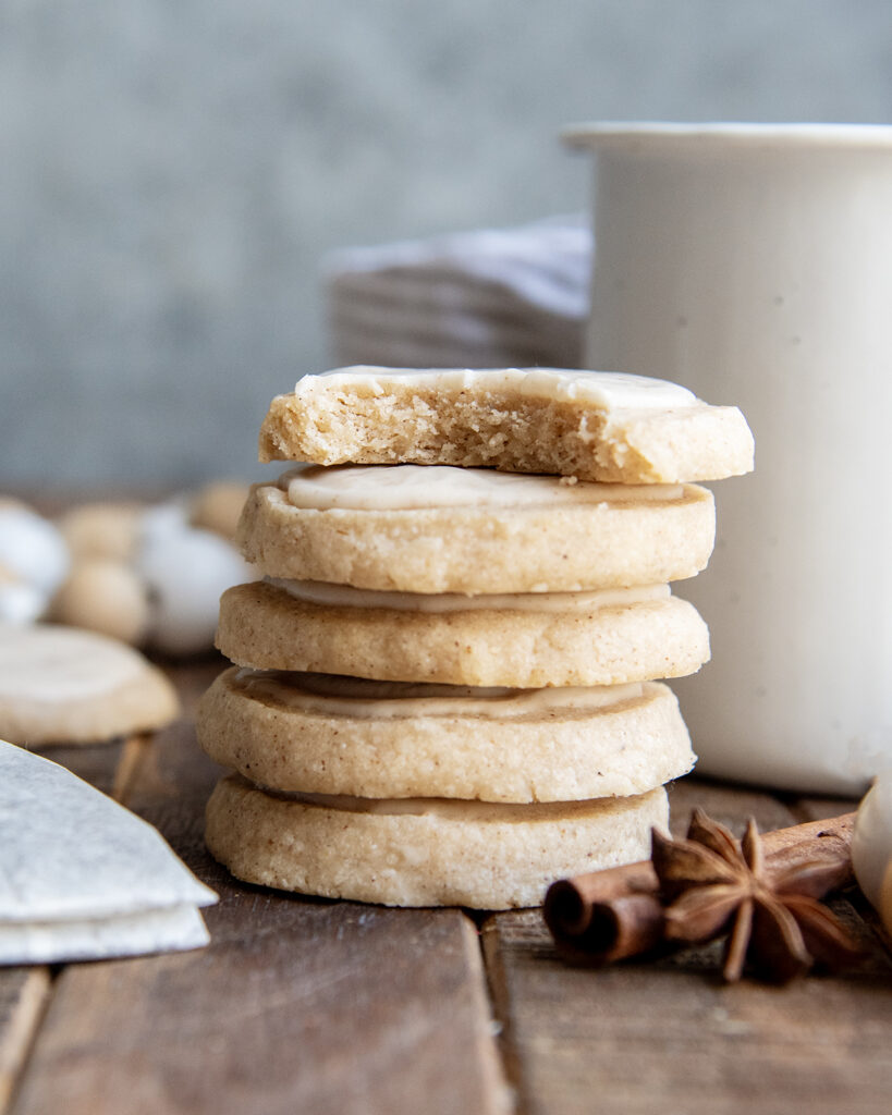 A stack of chai shortbread cookies, and the top cookie has a bite out of it.