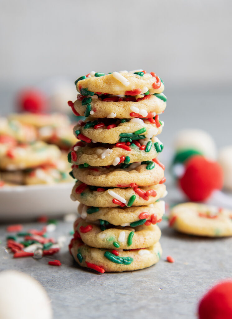 A stack of miniature christmas sprinkle sugar cookies.