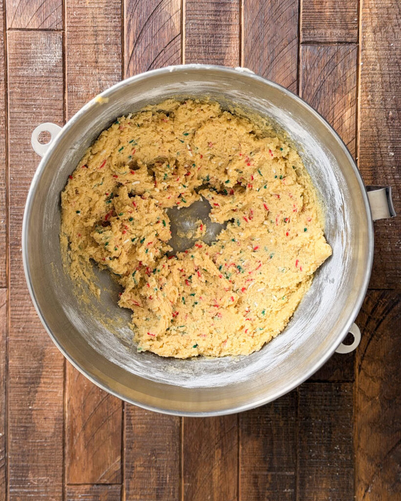 Sprinkle cookie dough in a metal mixing bowl.