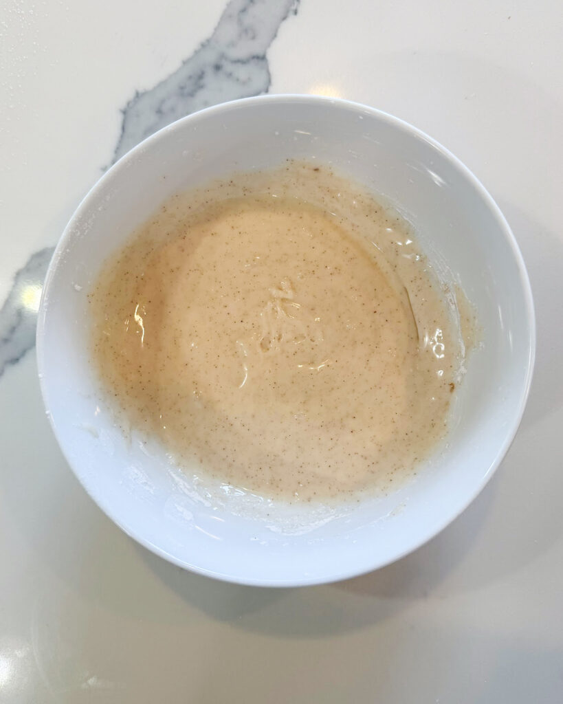A small bowl of vanilla cinnamon icing.