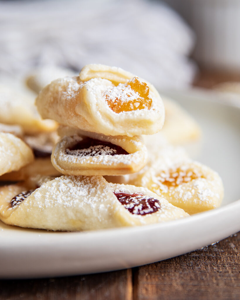 A stack of kolacky cookie on a plate.