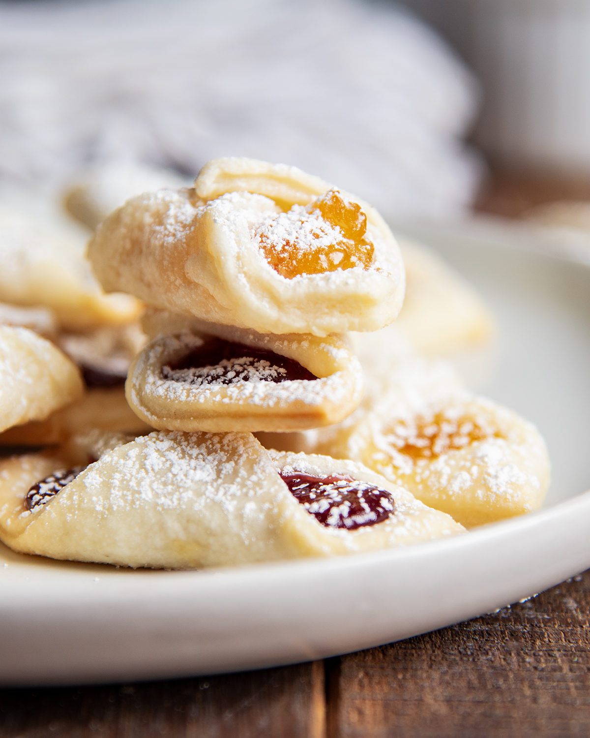 A stack of kolacky cookie on a plate.