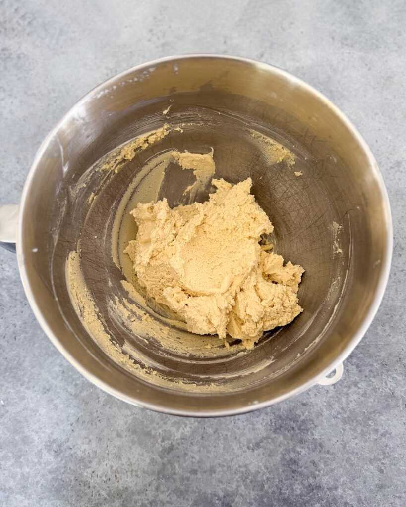 Shortbread bars cookie dough in a metal bowl.
