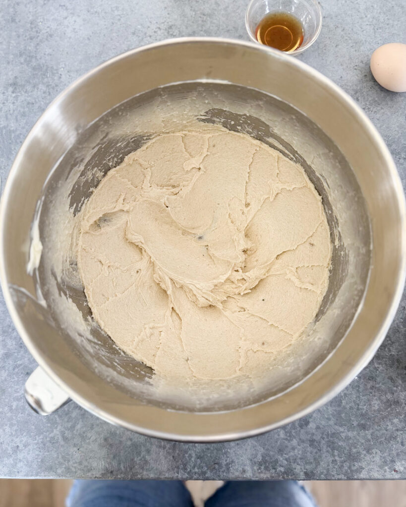 Fluffy creamed butter and sugars in a large metal bowl.