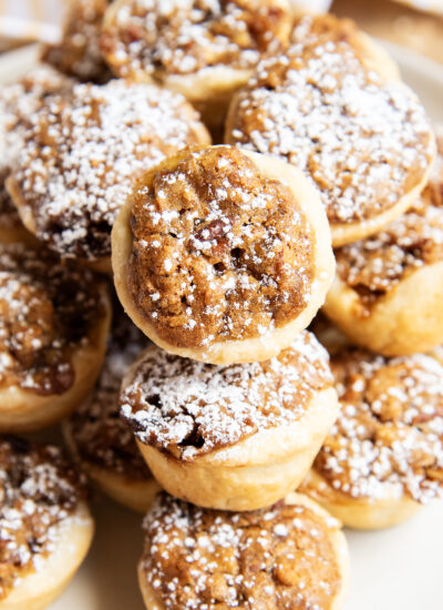 A close up of pecan tassies in a pile.
