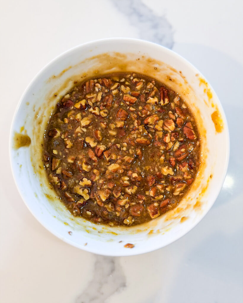 Pecan tassie filling in a small bowl.