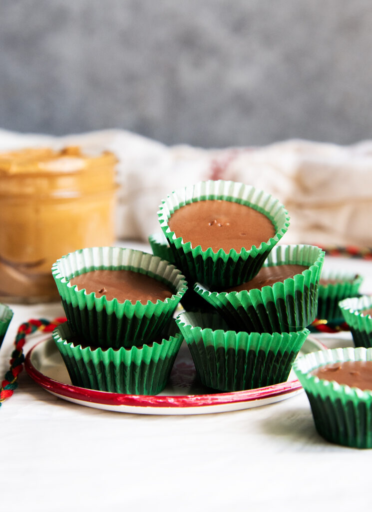 A plate of scotcheroo meltaways in green paper liners.