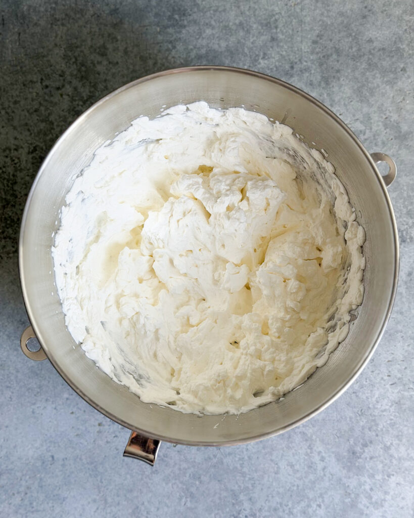 A mixing bowl with whipped cream.