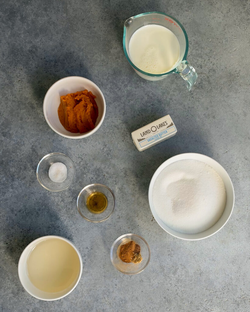 Small bowls of the ingredients needed to make pumpkin spice caramels.