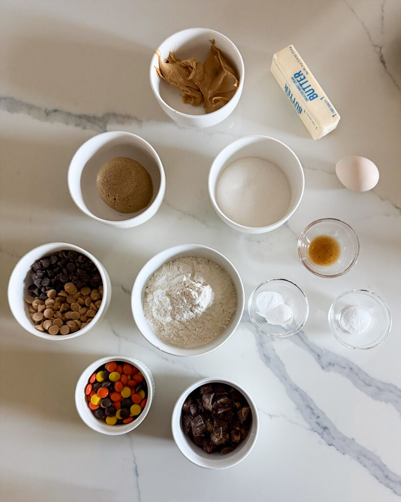 Small bowls of the ingredients needed to make Loaded Peanut Butter Cookies