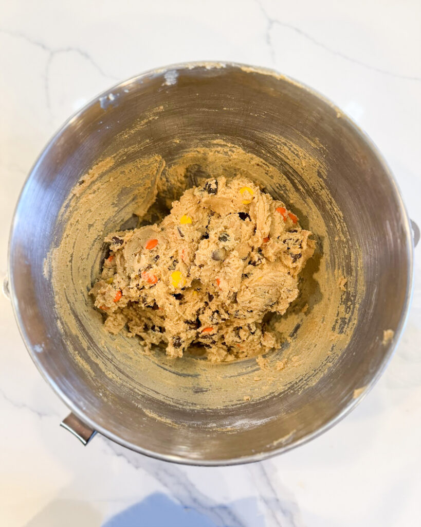 Peanut butter cookie dough in a metal bowl.