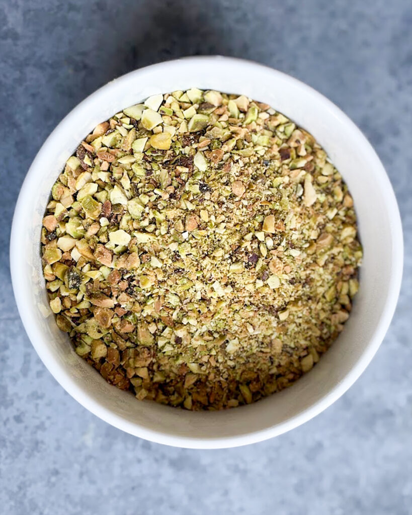 Finely chopped pistachios in a bowl. 