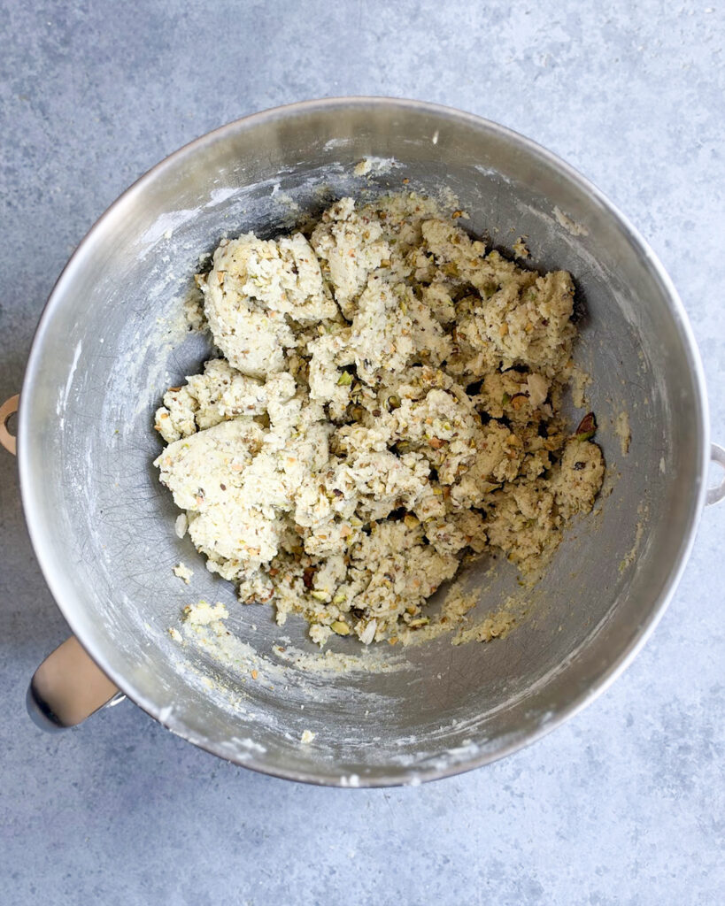 Pistachio snowball cookie dough in a bowl.